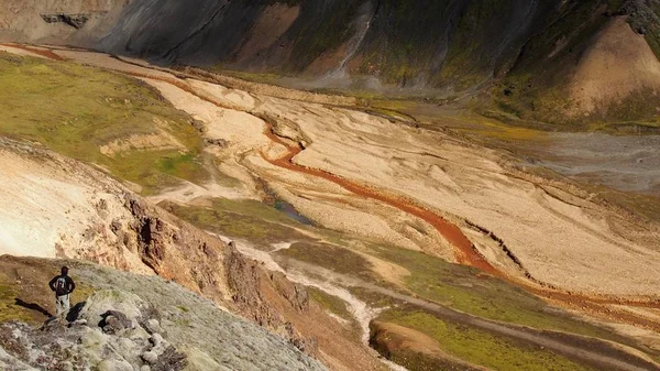 Magnificent mountains landscape with walking tourist