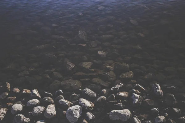 Rocky lake water flow  at the daytime