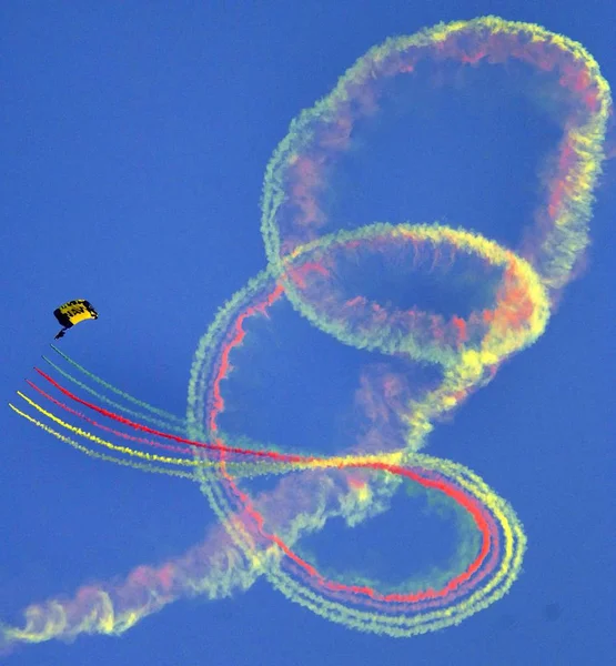 Colorful Parachute Jump in blue sky