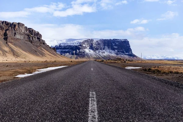 empty road with mountain on the background