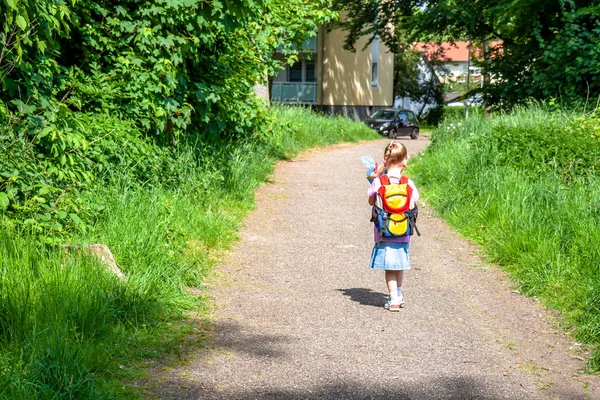 Little girl on her way to her first day of school — Stock Photo, Image