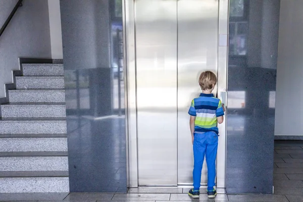 Küçük çocuk asansörü çağırıyor