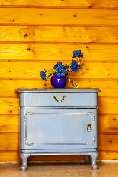 Ancient blue drawers placed in front of wooden wall — Stock Photo, Image