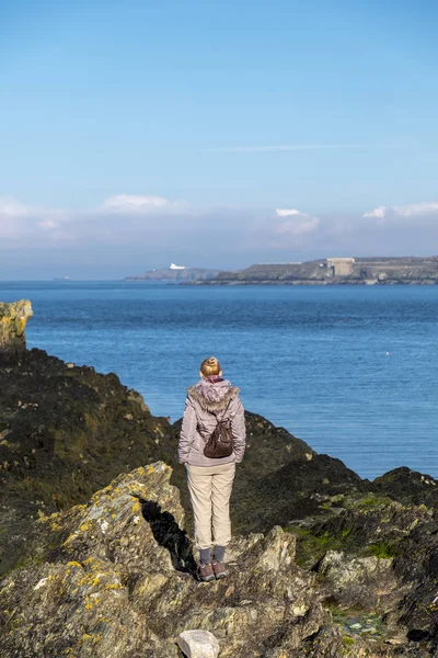 Dame beobachtet das Meer in der Bullenbucht auf Anglesey, Wale — Stockfoto