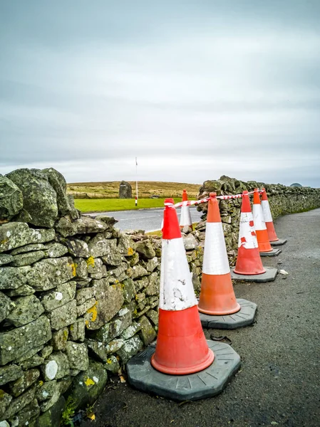 Traffic cones protecting traditional dry stone wall — Stock Photo, Image