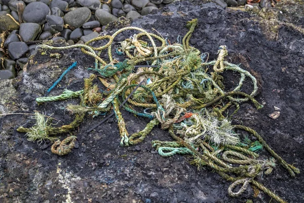 Knot of old rotten fishing ropes on pier.