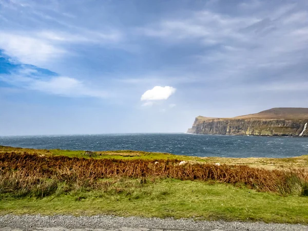 Waterfall on the left stopped and reversed by autumn storm Callum on the cliffs seen from Lower Milovaig - Isle of Skye, Scotland