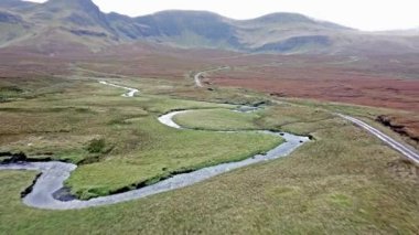 Flying over the River Lealt and Single track at Loch Cuithir and Sgurr a Mhadaidh Ruadh - Hill of the Red Fox, Isle of Skye, Scotland