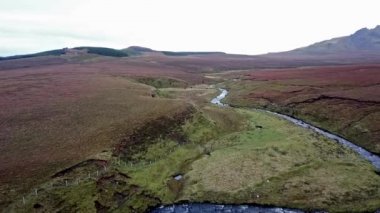 Flying over the River Lealt and Single track at Loch Cuithir and Sgurr a Mhadaidh Ruadh - Hill of the Red Fox, Isle of Skye, Scotland