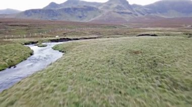Flying over the River Lealt and Single track at Loch Cuithir and Sgurr a Mhadaidh Ruadh - Hill of the Red Fox, Isle of Skye, Scotland