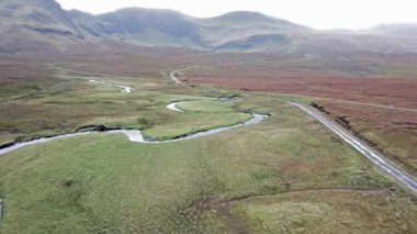 Flying over the River Lealt and Single track at Loch Cuithir and Sgurr a Mhadaidh Ruadh - Hill of the Red Fox, Isle of Skye, Scotland