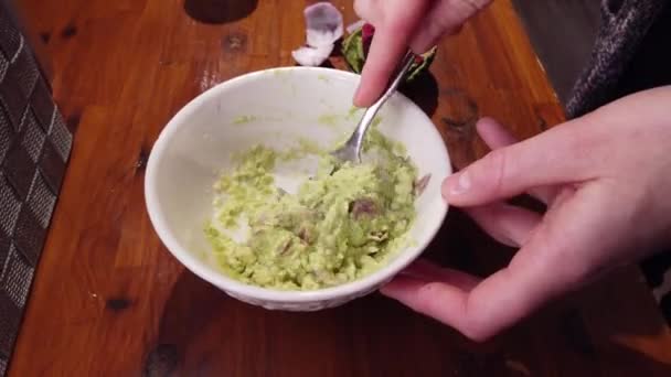 Closeup of guacamole mixed at desktop in home kitchen — Stock Video