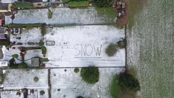 Volando por encima de la palabra nieve escrita en la nieve — Vídeo de stock