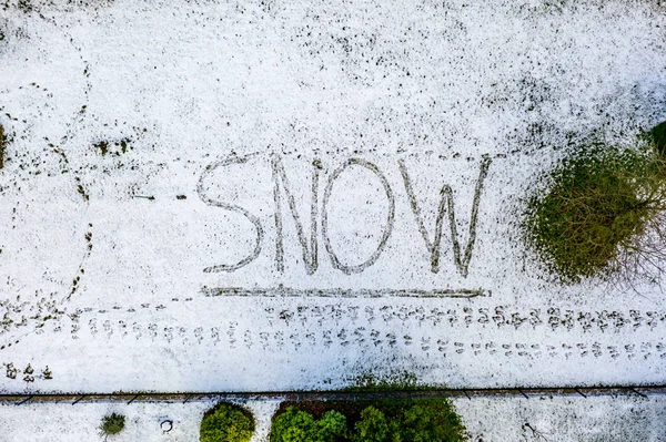 Flying above the word snow written in snow