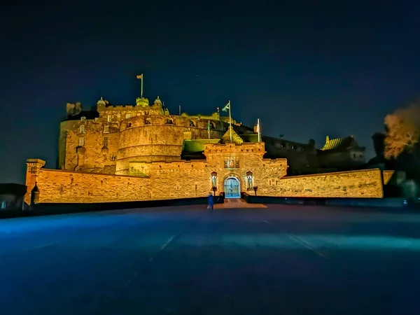 Edinburgh castle at night with the historic red Lion rampant crest - Translation of the latin Nemo me impune lacessit : No one can harm me unpunished