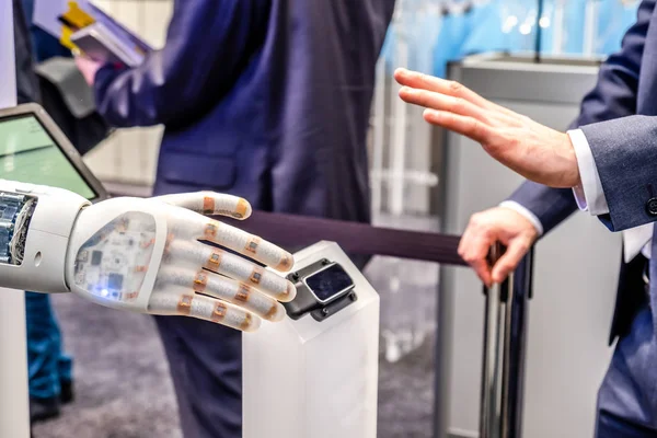 Human hand and robots as a symbol of connection between people and artificial intelligence technology