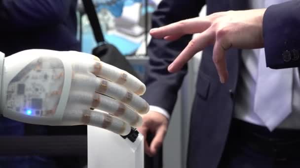 La mano humana y los robots como símbolo de conexión entre las personas y la tecnología de inteligencia artificial — Vídeos de Stock