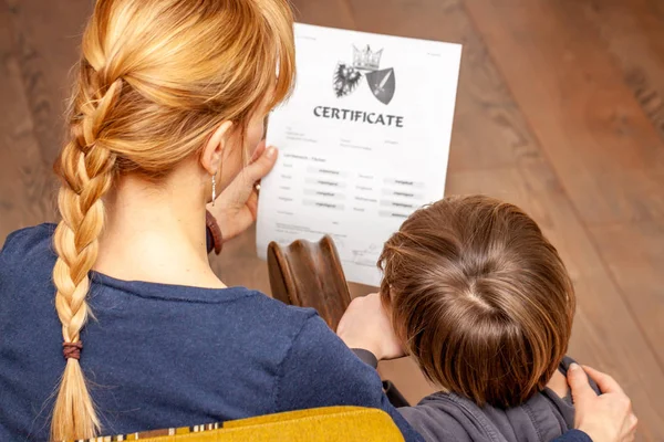 Mother comforting son despite the bad school certificate — Stock Photo, Image