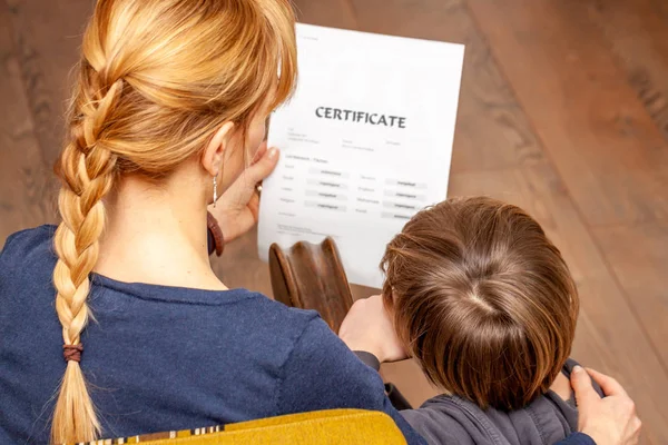 Mother comforting son despite the bad school certificate — Stock Photo, Image