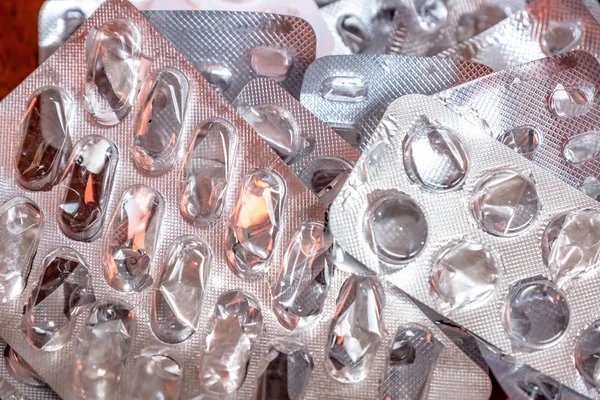 Empty blister packaging of medicine pills on wooden table