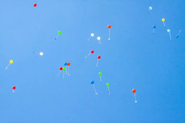 Colorful ballons with letters flying in the blue sky
