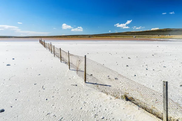 Old fence in a salt lake in Tierra del Fuego in Argentina — Stock Photo, Image