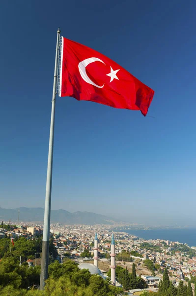 View at Izmir city from a hill above and a flag — Stock Photo, Image