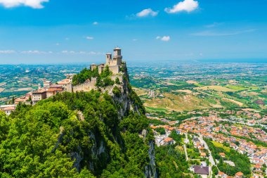 Mighty Guaita Tower and fortress on Mount Titano above the Republic of San Marino clipart