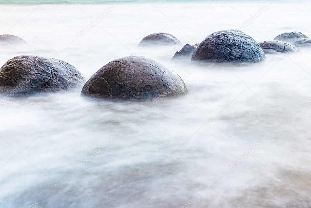 Moeraki Boulders on the Koekohe beach, Eastern coast of New Zealand. 