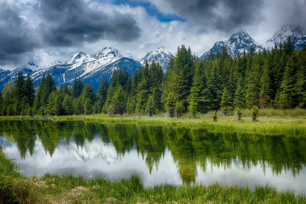 Reflection of the mountain peaks at Schwabacher landing, Grand Teton national park. Wyoming, USA 