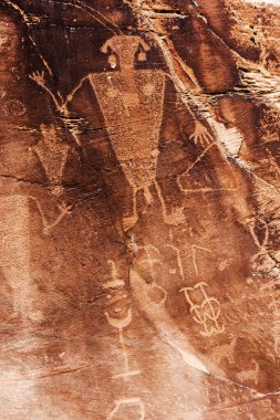 Man rock art (petroglyphs) by ancient Fremont people - native Americans - seen during hiking at Dinosaur National Monument in Utah, USA clipart