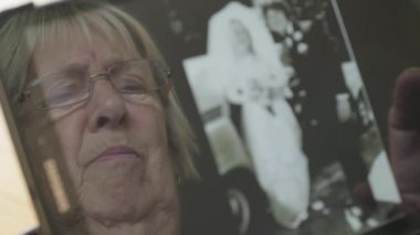 Beyaz kadın kendini bir tablet bilgisayarda eski fotoğrafları bakarak kıdemli