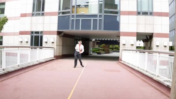 Happy Carefree Caucasian Businessman Leaving Office Wearing Headphones Listening Music — Stock Video