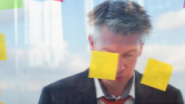 Reflection Creative Businessman Brainstorming Ideas Putting Post Notes Window Plain — Stock Video
