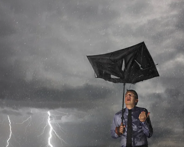 Businessman caught in a storm — Stock Photo, Image