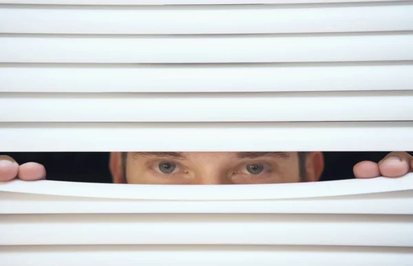Looking through slats of blinds — Stock Photo, Image