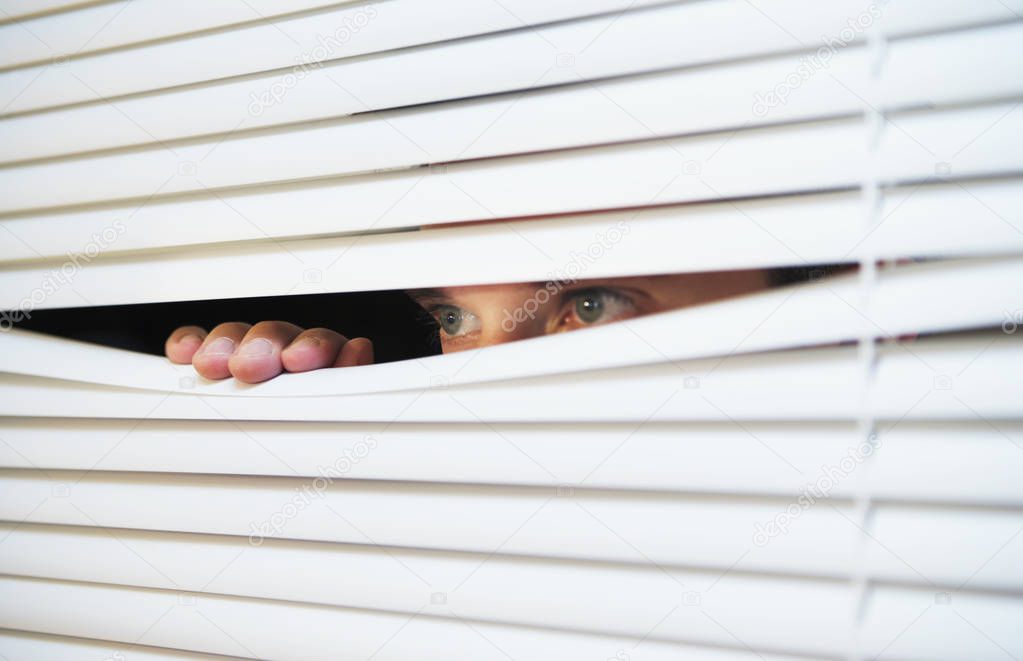 Looking through the slats of a blind