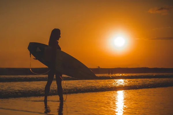 surfer woman with surfboard in sea water