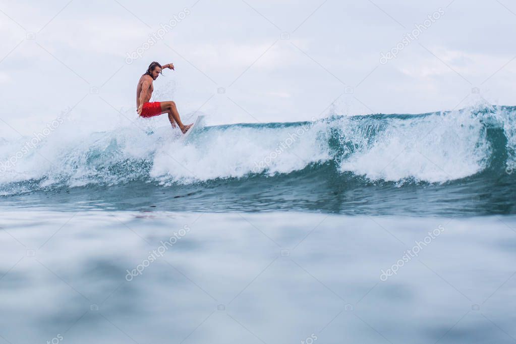 surfer riding the waves in bali. Picture from the water