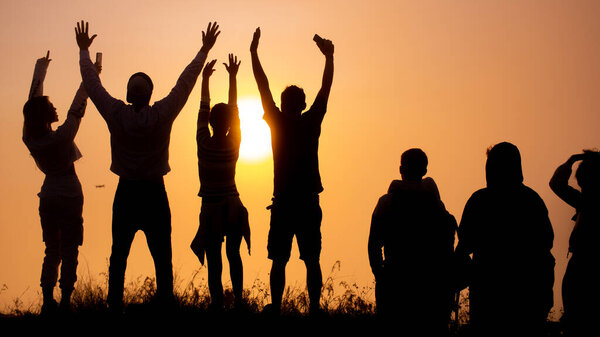 silhouettes of tourists meeting the dawn on the volcano Batur, Bali, Indonesia