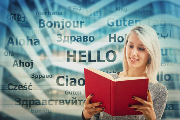 Student girl holding a dictionary and word hello translated in different languages on the background. Young school teacher learning and speaking many languages. International communication concept.