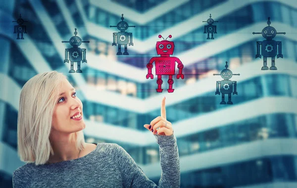 Beautiful blonde woman pointing her finger up choosing a different robot. Employee choice, group of artificial intellect replace human, leadership concept. Modern technology workforce candidates.