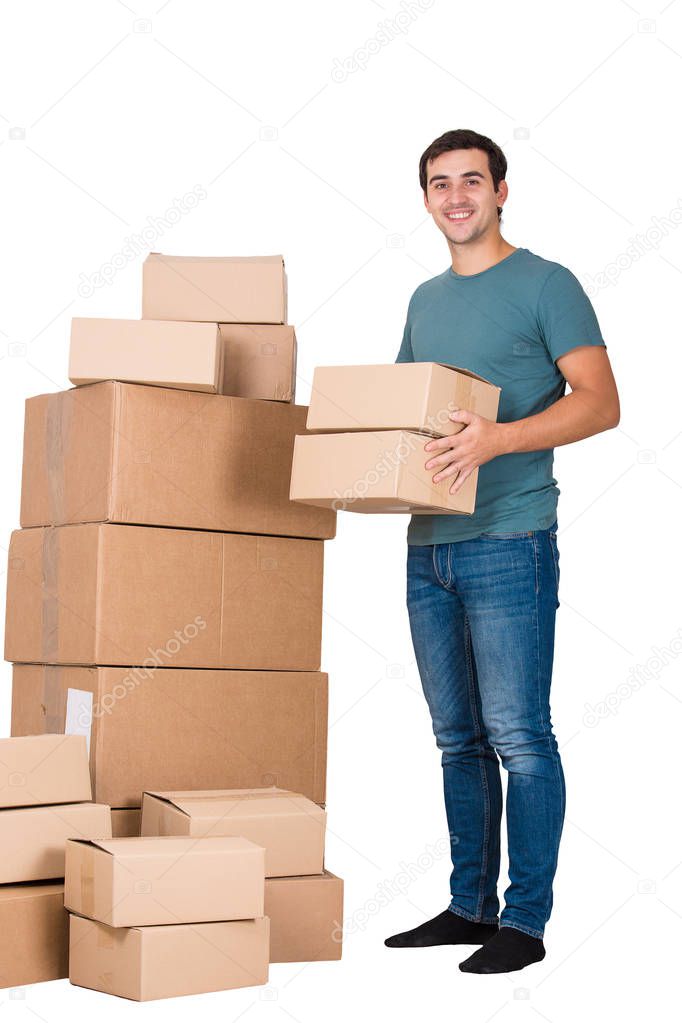Full length portrait of happy young man packing and carry boxes ready to move into new house isolated over white background.