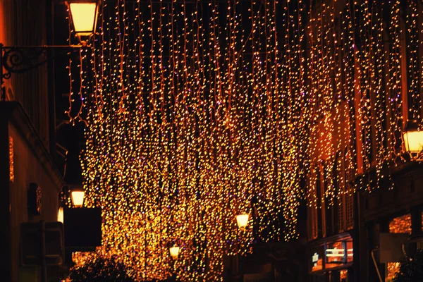 Blurred colorful lights on the city street. Chrismas decorations holiday bokeh background.