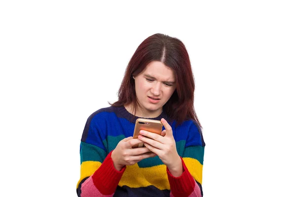 困惑的年轻女子看着她的智能手机与震惊的脸情绪孤立在白色的背景 — 图库照片