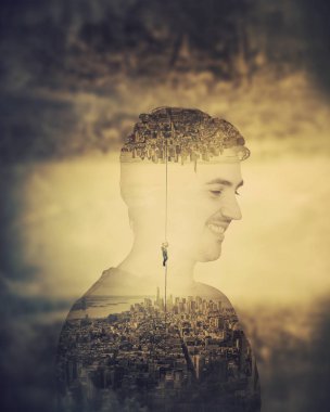 Smiling man surreal double exposure effect as mystical cityscape parallel worlds inside his head. Imagine himself hanging on chain to escape from reality. Change, risk and conquering metaphor.