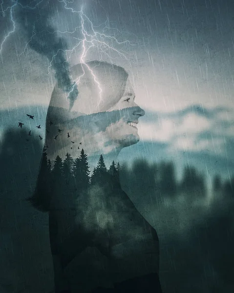 Happy young woman traveler spirit silhouette double exposure effect over foggy mountains fir forest. Relaxing duotone cold landscape with storm in the woods and lightnings. Adventure concept.