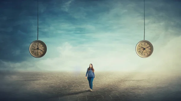 Surreal Scene Young Woman Walking Pavement Road Two Suspended Clocks — Stock Photo, Image