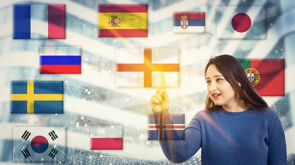 Woman touch a digital screen interface with national flags showing different languages spoken around the world. Learning and speaking using modern technology. International communication concept.