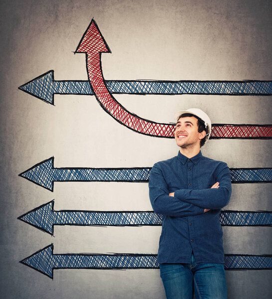 Man engineer holding hands crossed imaginning arrows sketch, one of them changing direction and go up, as a progress graph. Business change and growth symbol, different thinking, alternative idea.